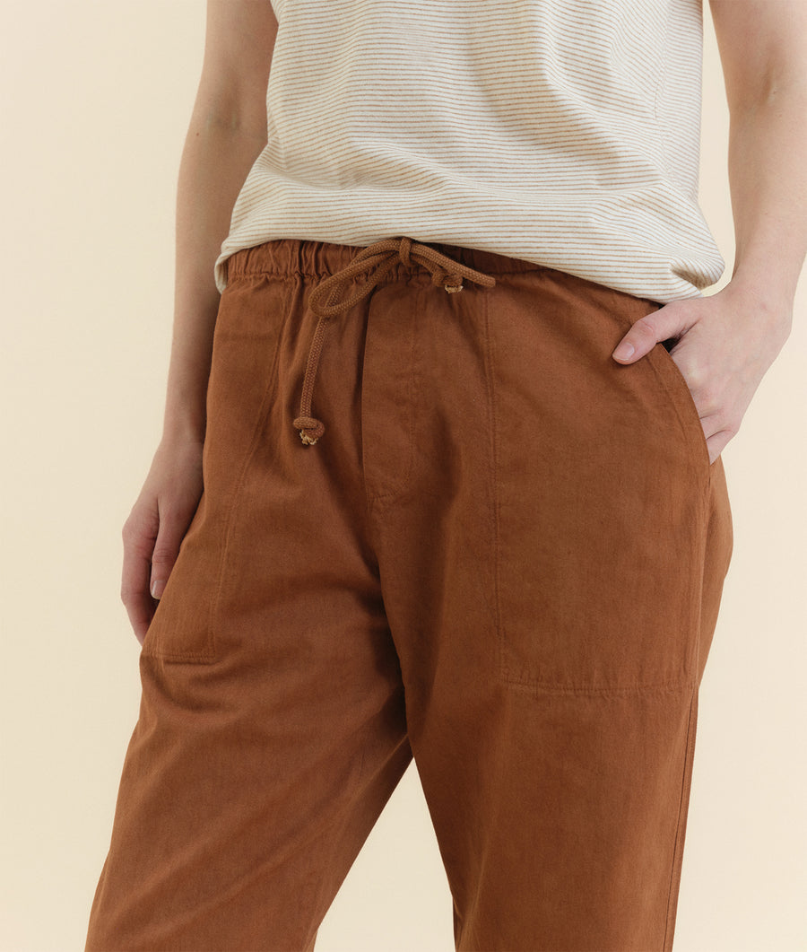 Brown relaxed-fit drawstring pants worn on model - Industry of All Nations