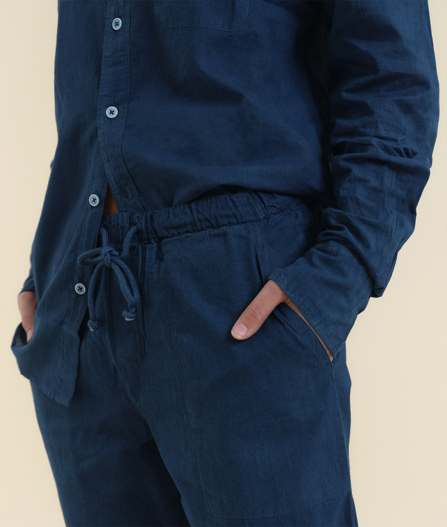 Close-up detail shot of a navy blue organic cotton jumpsuit with drawstring waist and pockets - Industry of All Nations