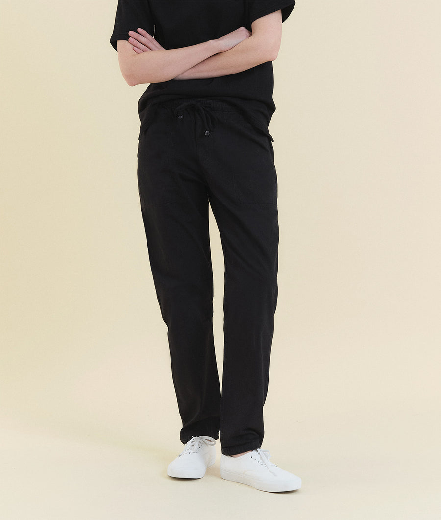 A model wearing black cotton drawstring pants with white sneakers - Industry of All Nations