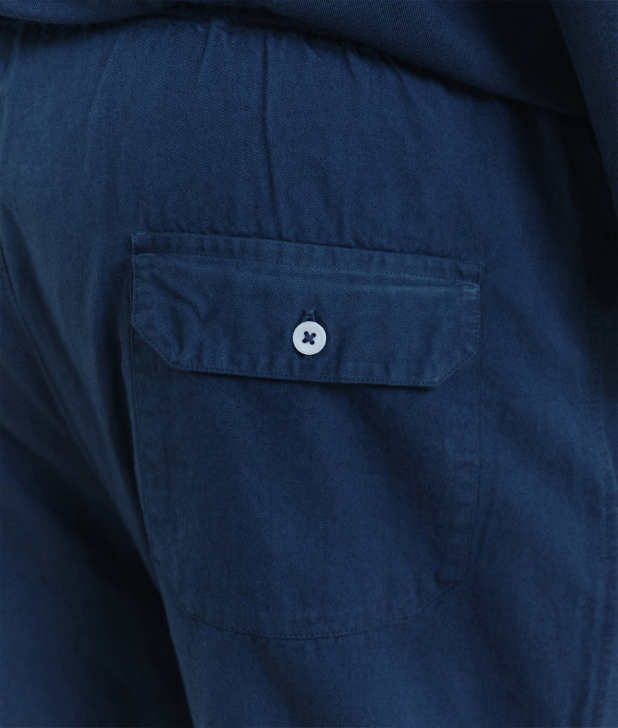 Close-up detail shot of a navy blue organic cotton jacket with a button pocket - Industry of All Nations