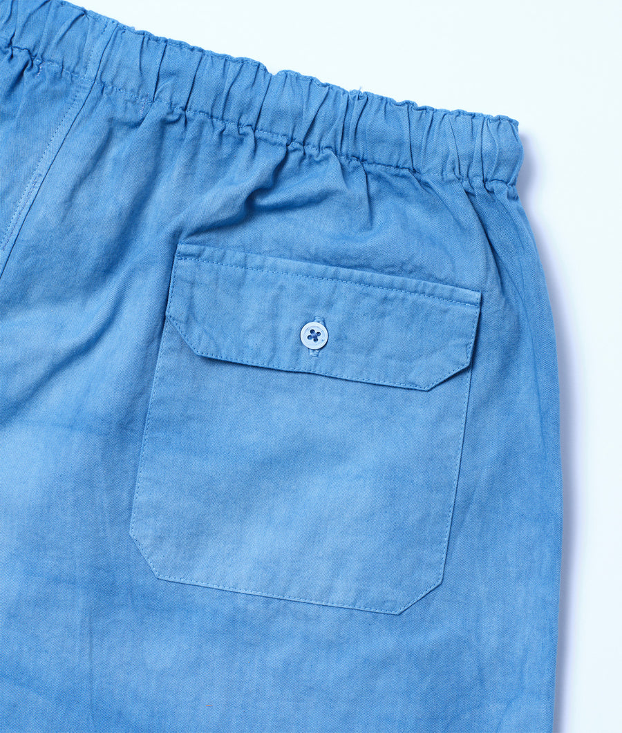 Detail shot of a light blue pair of organic cotton shorts with a buttoned cargo pocket - Industry of All Nations