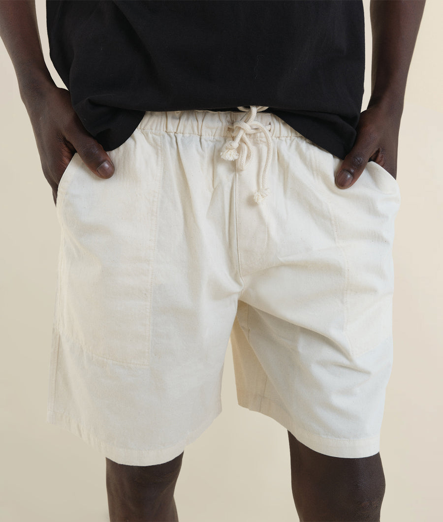 White cotton drawstring shorts worn by a model - Industry of All Nations