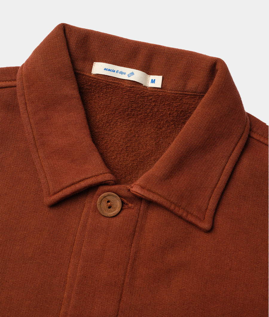 Rust-colored sweater with a shawl collar, wooden button, and Acacia brand tag - Industry of All Nations