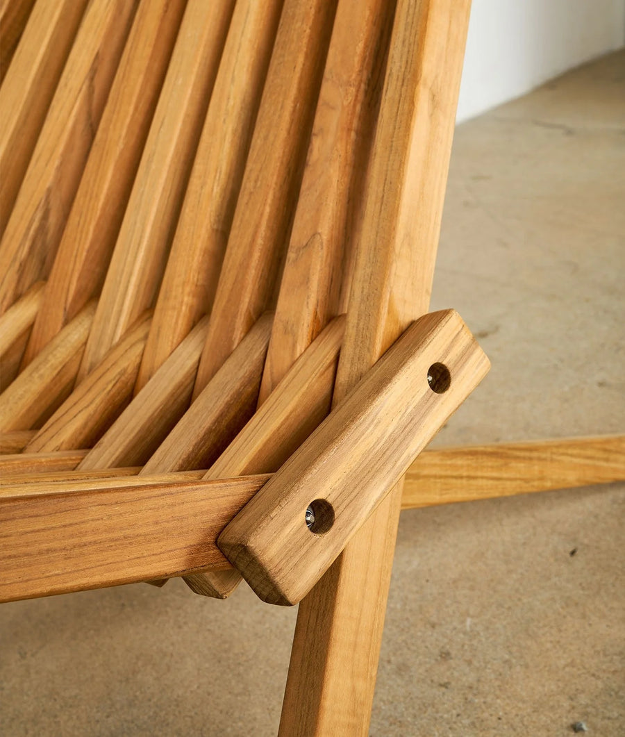 Detail shot of a wooden chair with a woven seat and backrest - Industry of All Nations