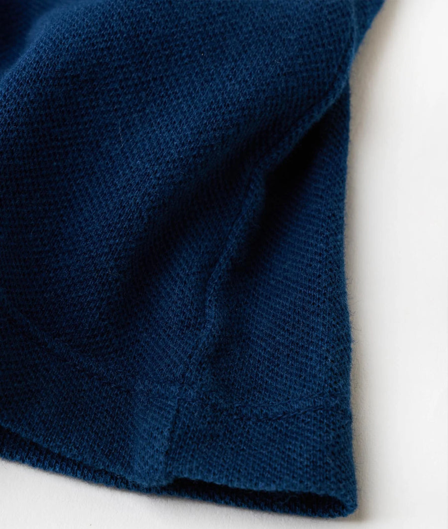 Close-up shot of a navy blue, textured knit sweater fabric - Industry of All Nations