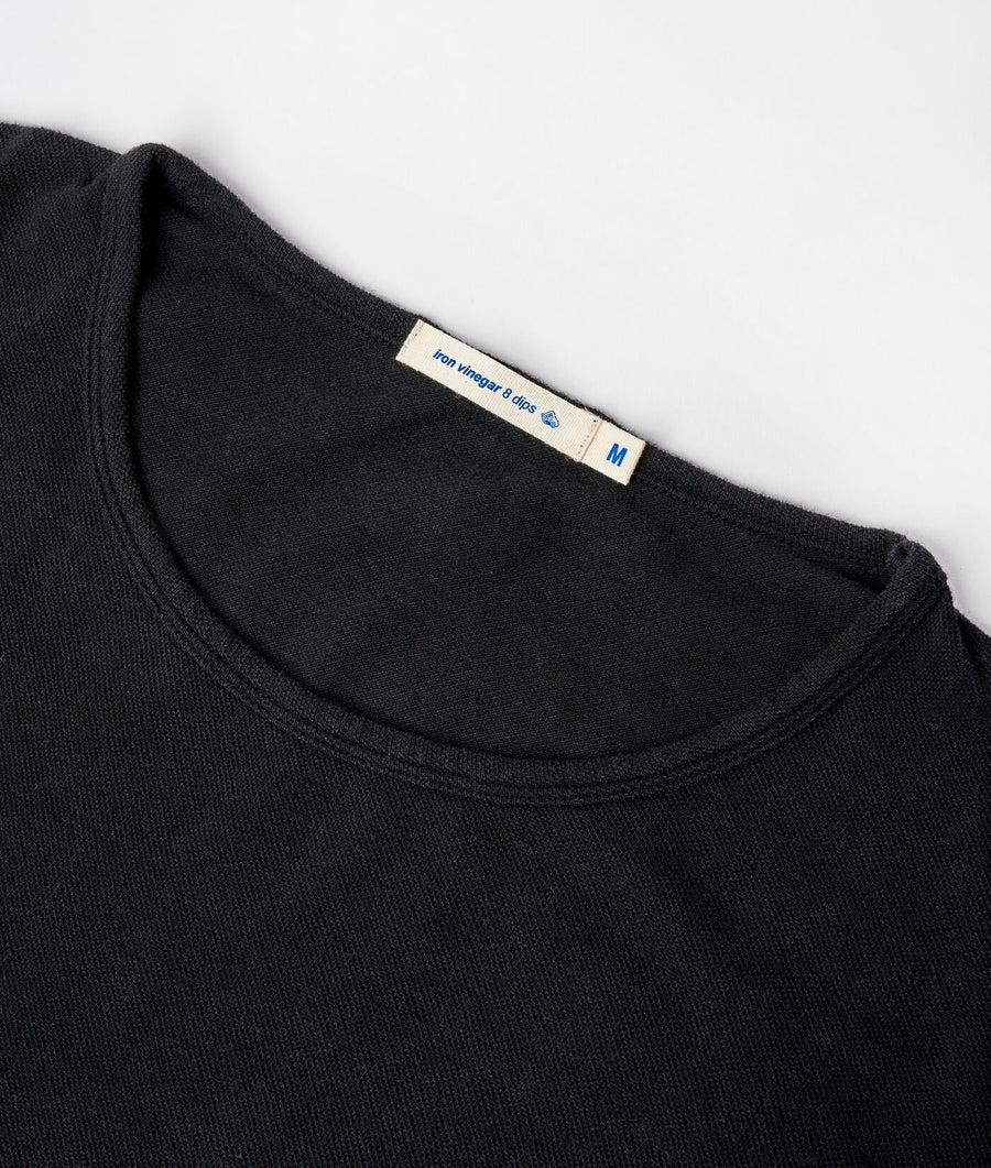 Black long-sleeved shirt with 'Iron winegar 6 clips' label, displayed in a close-up detail shot - Industry of All Nations