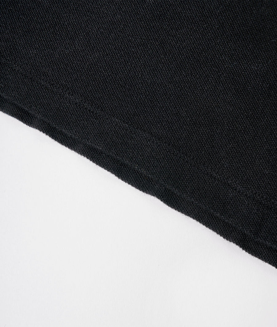 A close-up detail shot of a black fabric texture - Industry of All Nations