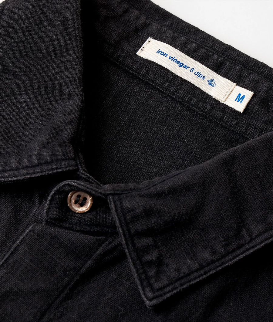 Black denim jeans with 'Iron Vinegar & dips' label, displayed in a close-up detail shot - Industry of All Nations