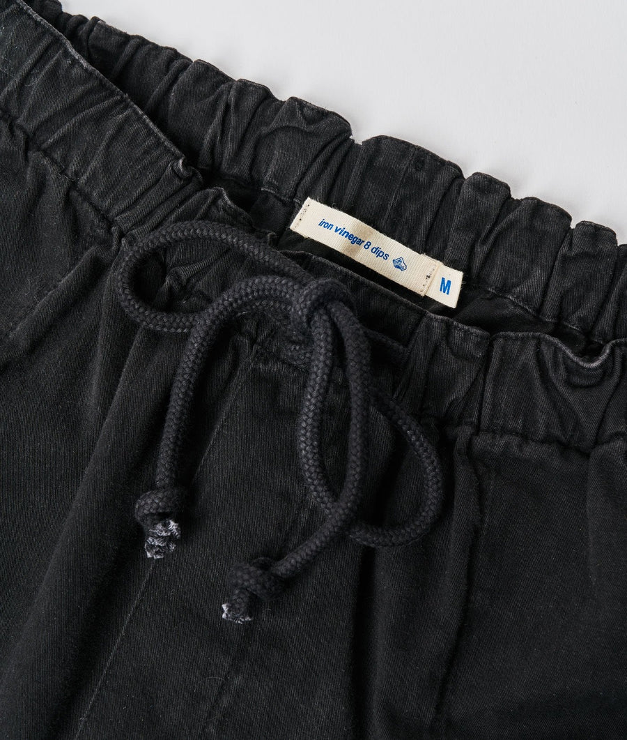 Black cotton drawstring sweatpants with elastic waistband, displayed as a flat lay shot - Industry of All Nations