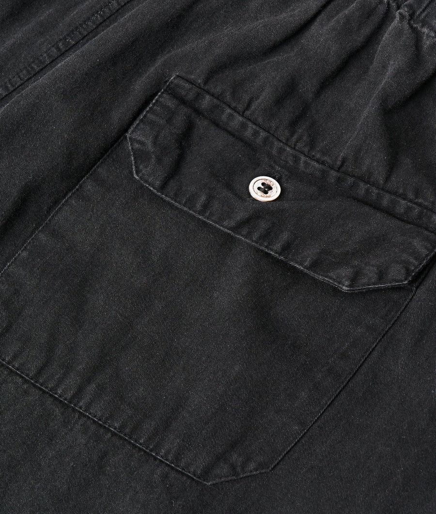 Detail shot of a black cotton work jacket with a small embroidered logo on the chest pocket - Industry of All Nations