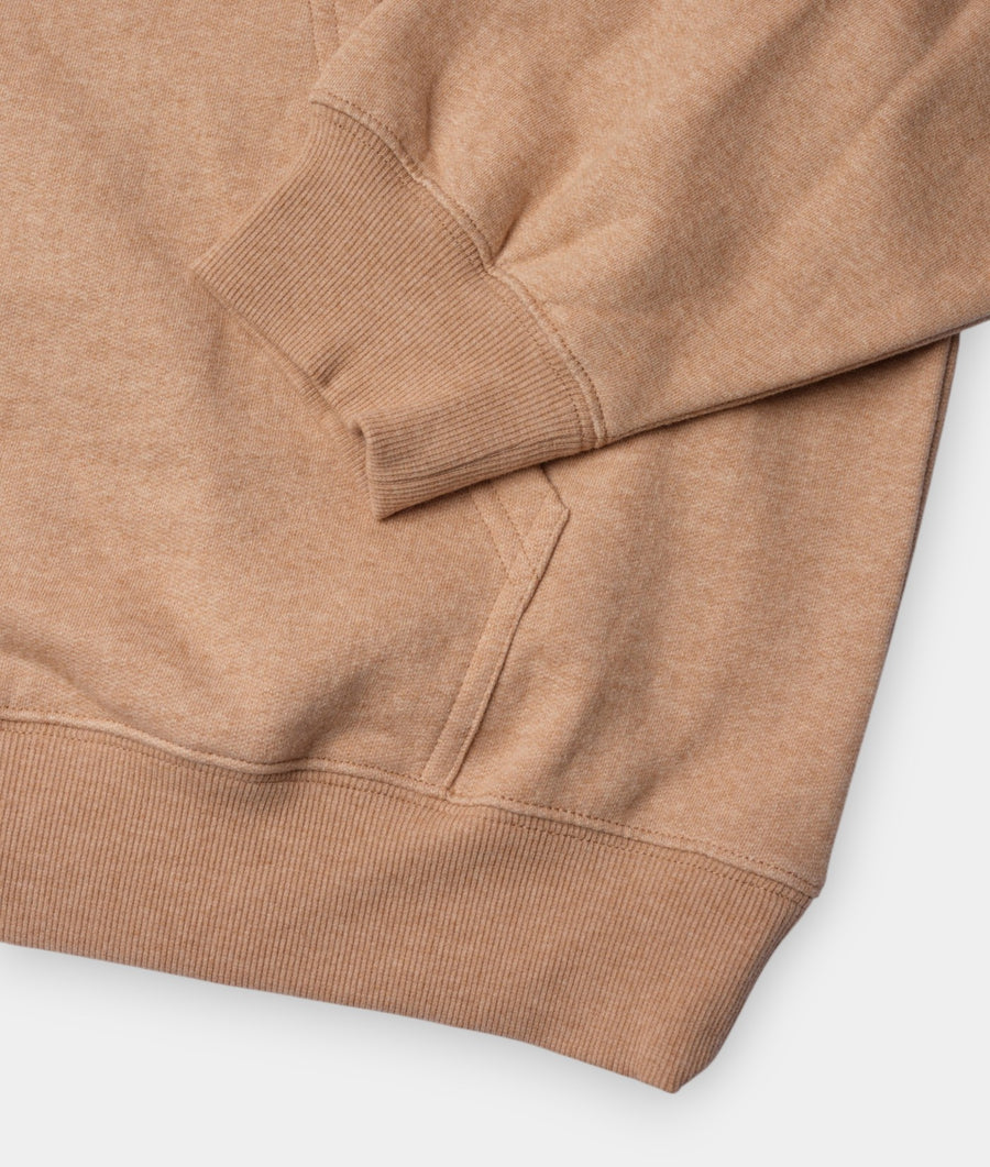 Close-up detail shot of a tan organic cotton pullover hoodie with ribbed sleeve cuffs and hem - Industry of All Nations