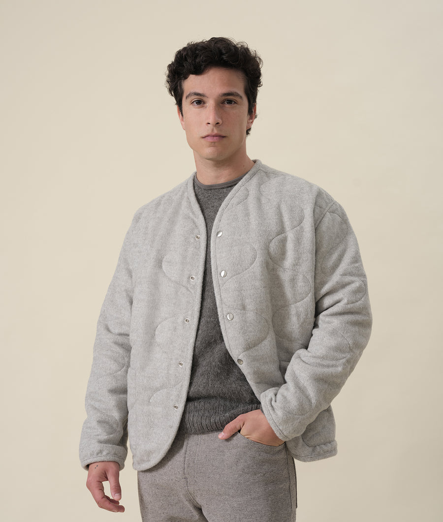 Gray woolen fleece jacket worn by a male model against a beige background - Industry of All Nations