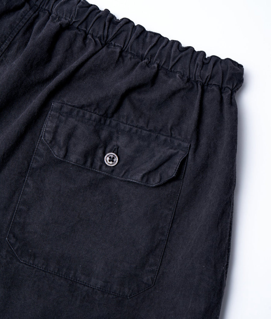 Close-up detail shot of a black, ruched waist elastic-waist short with a single pocket - Industry of All Nations