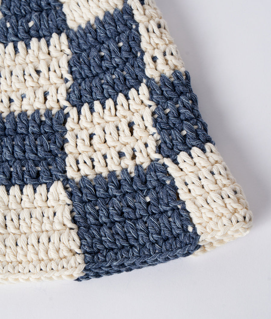 Crocheted scarf in navy blue and cream, displayed as a flat lay detail shot - Industry of All Nations