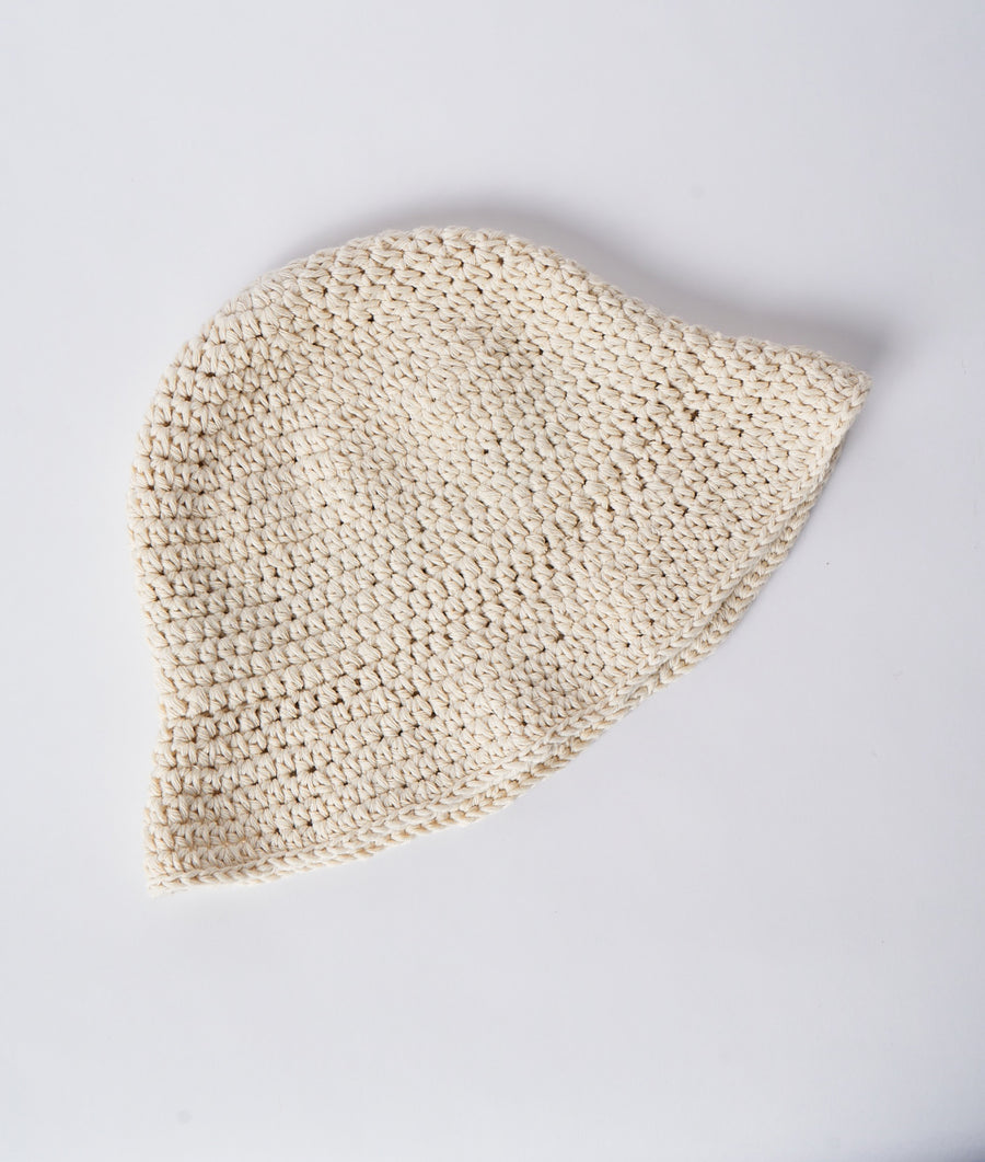 A cream-colored crocheted bucket hat displayed on a plain white background - Industry of All Nations