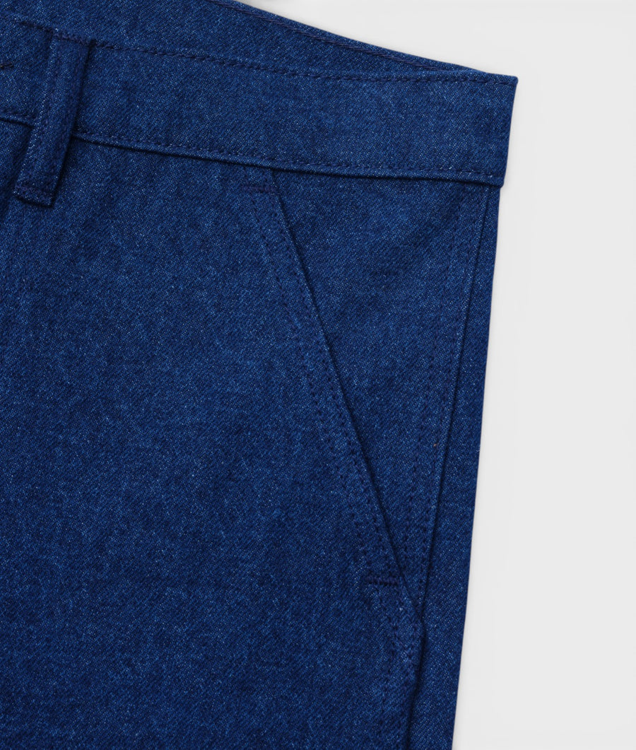 Close-up of the waistband and pocket details of a pair of dark blue organic cotton denim pants - Industry of All Nations