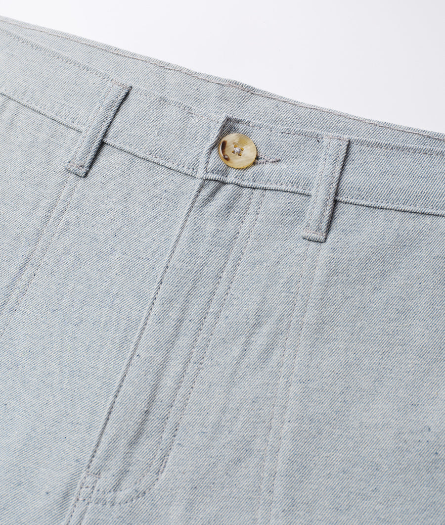 A gray cotton chino pant displaying a single beige button in a detail shot - Industry of All Nations