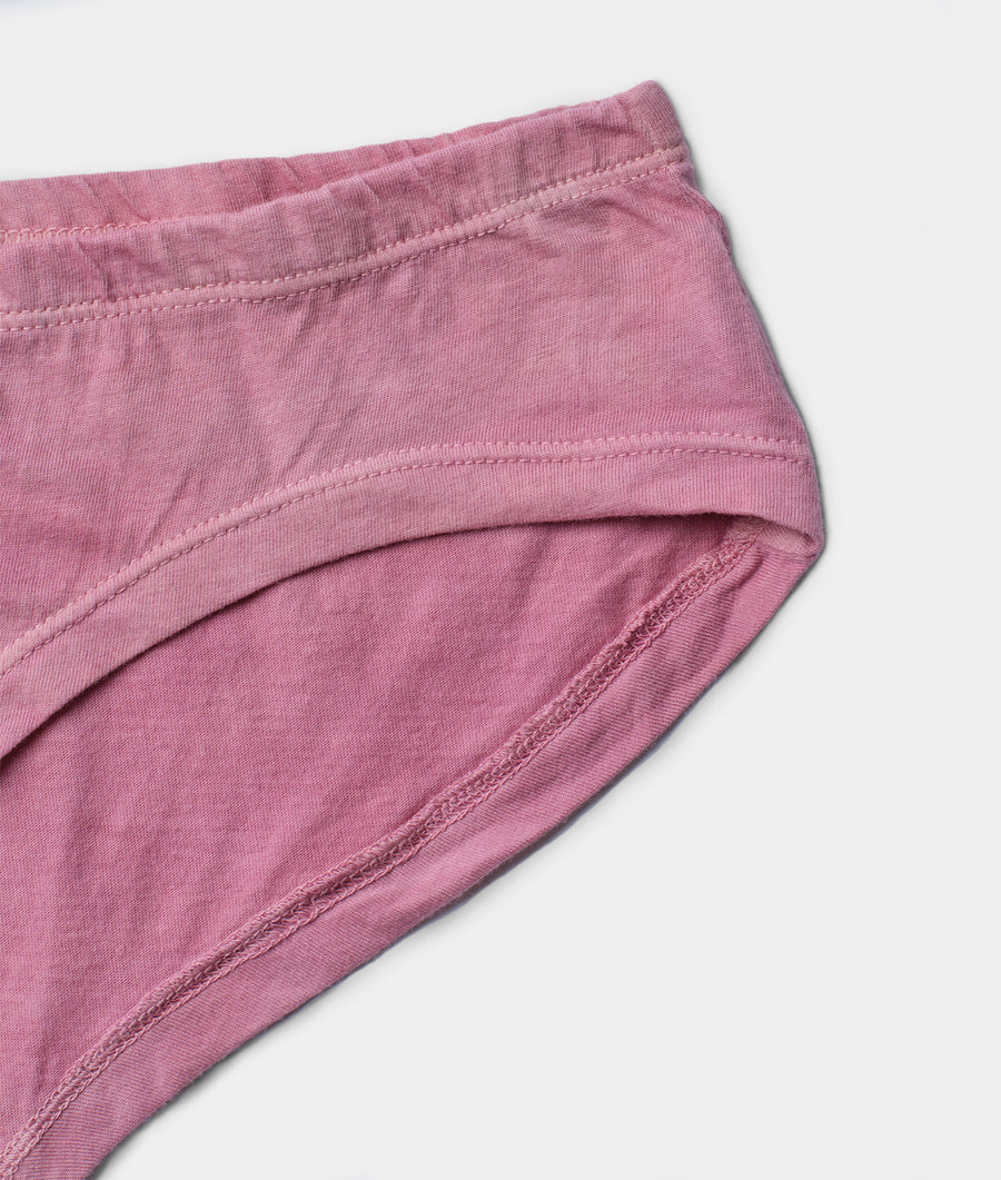 Close-up detail shot of a pair of soft, dusty pink organic cotton underwear - Industry of All Nations