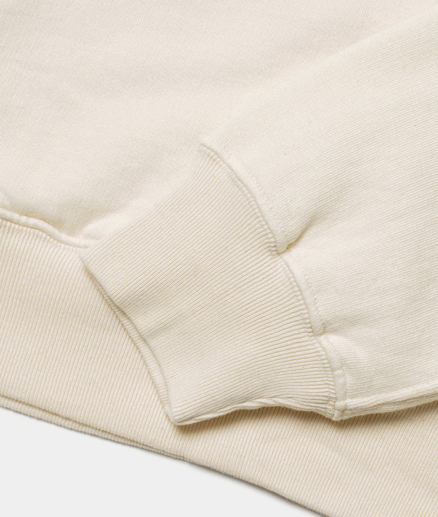 Close-up detail shot of an off-white organic cotton ribbed sweater - Industry of All Nations