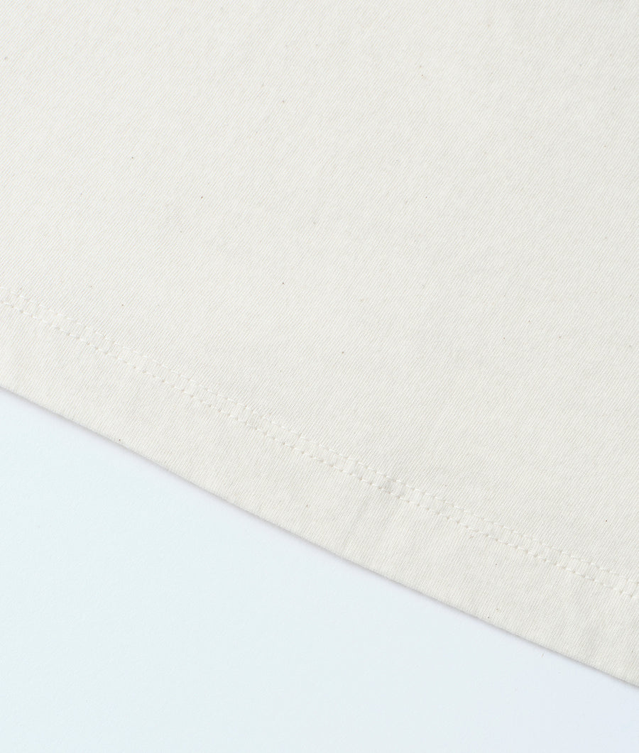 Cream-colored organic cotton knit pullover sweater, displayed in a flat lay - Industry of All Nations