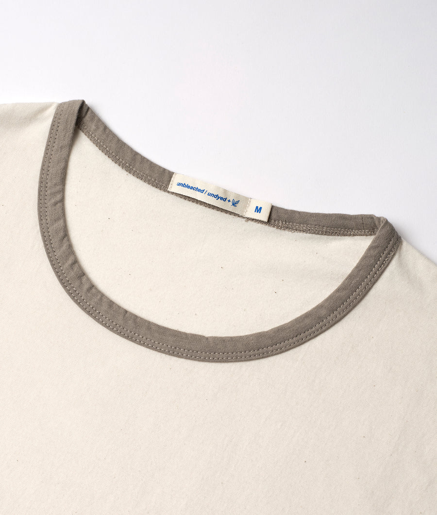 Cream-colored, unbleached and undyed cotton t-shirt with gray trim, displayed in a flat lay shot - Industry of All Nations