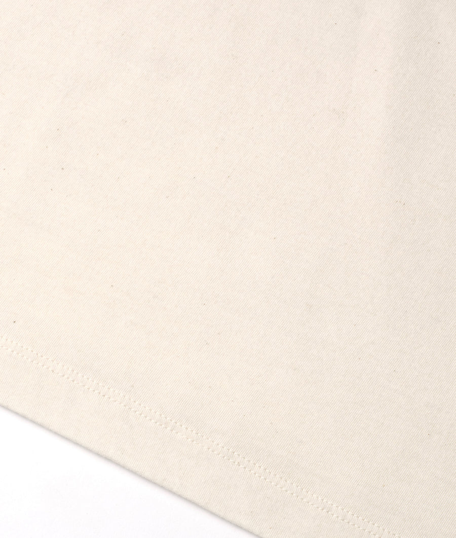 Cream-colored organic cotton knit fabric displayed in a flat lay arrangement - Industry of All Nations