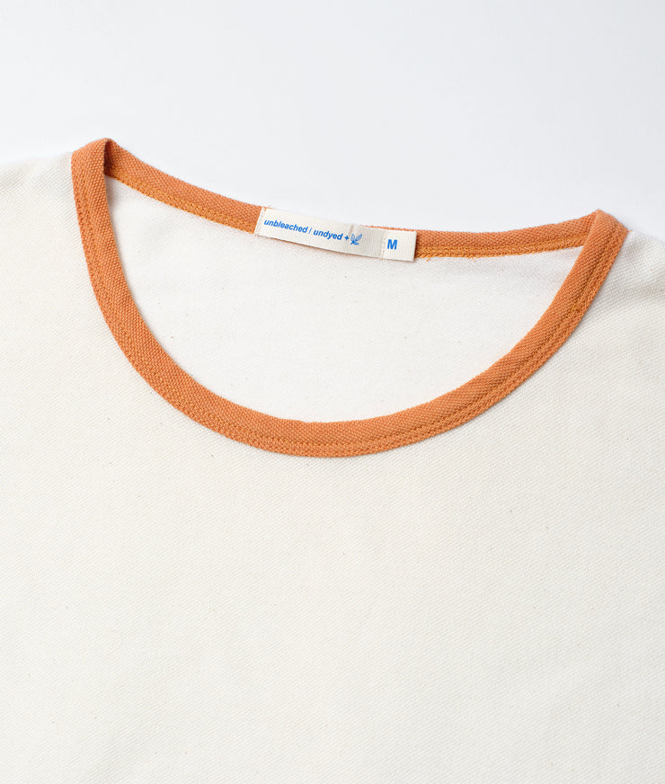 Close-up of a crewneck shirt collar with a label on a white background