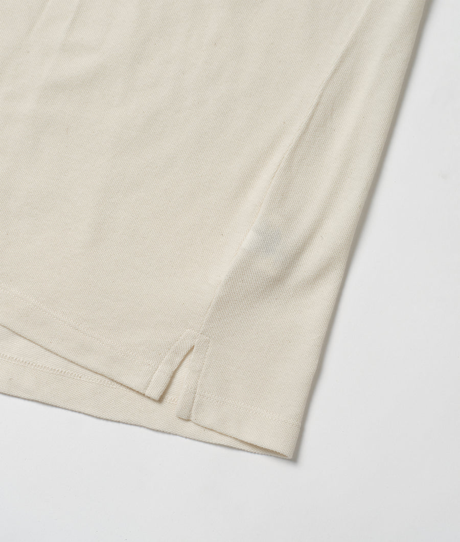 Close-up detail shot of a cream-colored organic cotton garment - Industry of All Nations