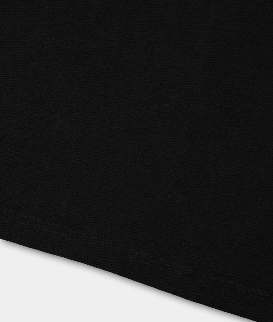 Black t-shirt displayed in a simple, minimalist flat lay - Industry of All Nations