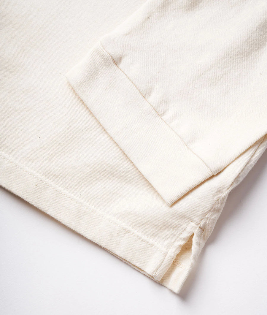 Detail shot of a white organic cotton garment from Industry of All Nations.