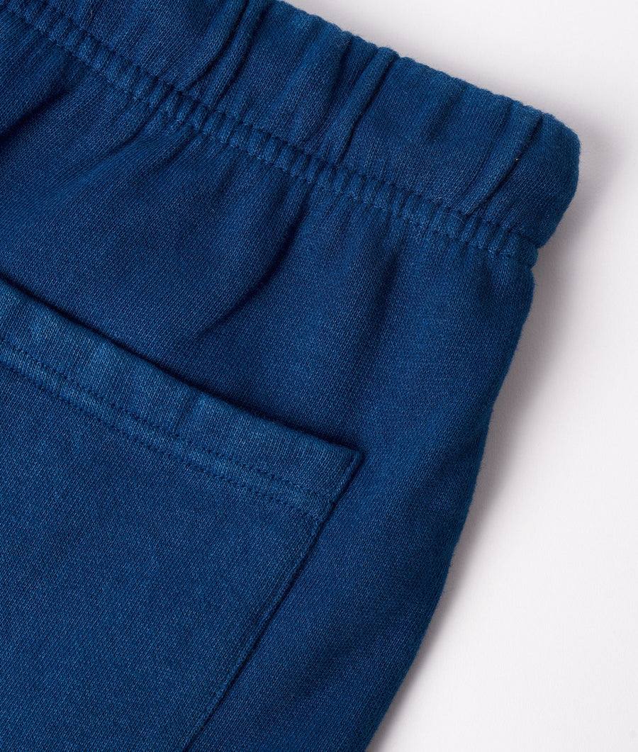Close-up of navy blue cotton jersey shorts with elastic waistband - Industry of All Nations