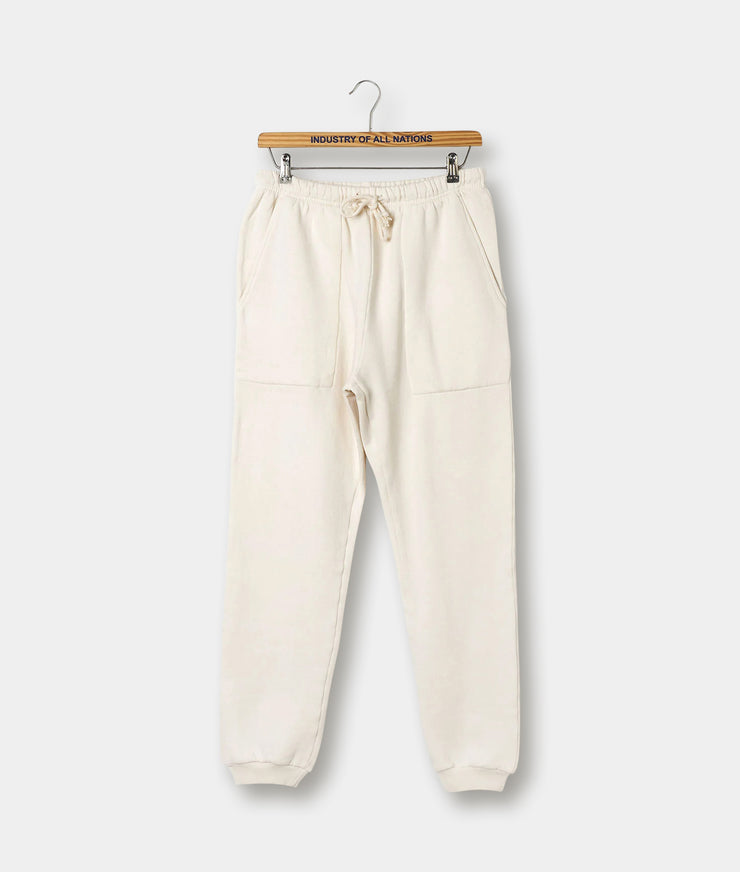 A pair of beige sweatpants with an elastic waistband and drawstrings, displayed on a wooden hanger.