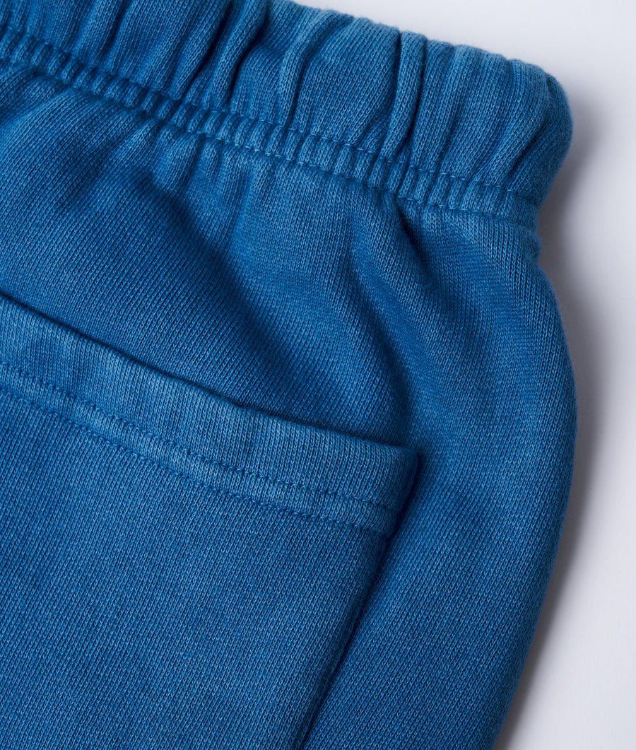 Detail shot of soft blue-teal colored sweatpants with ribbed elastic waistband and cuffs - Industry of All Nations