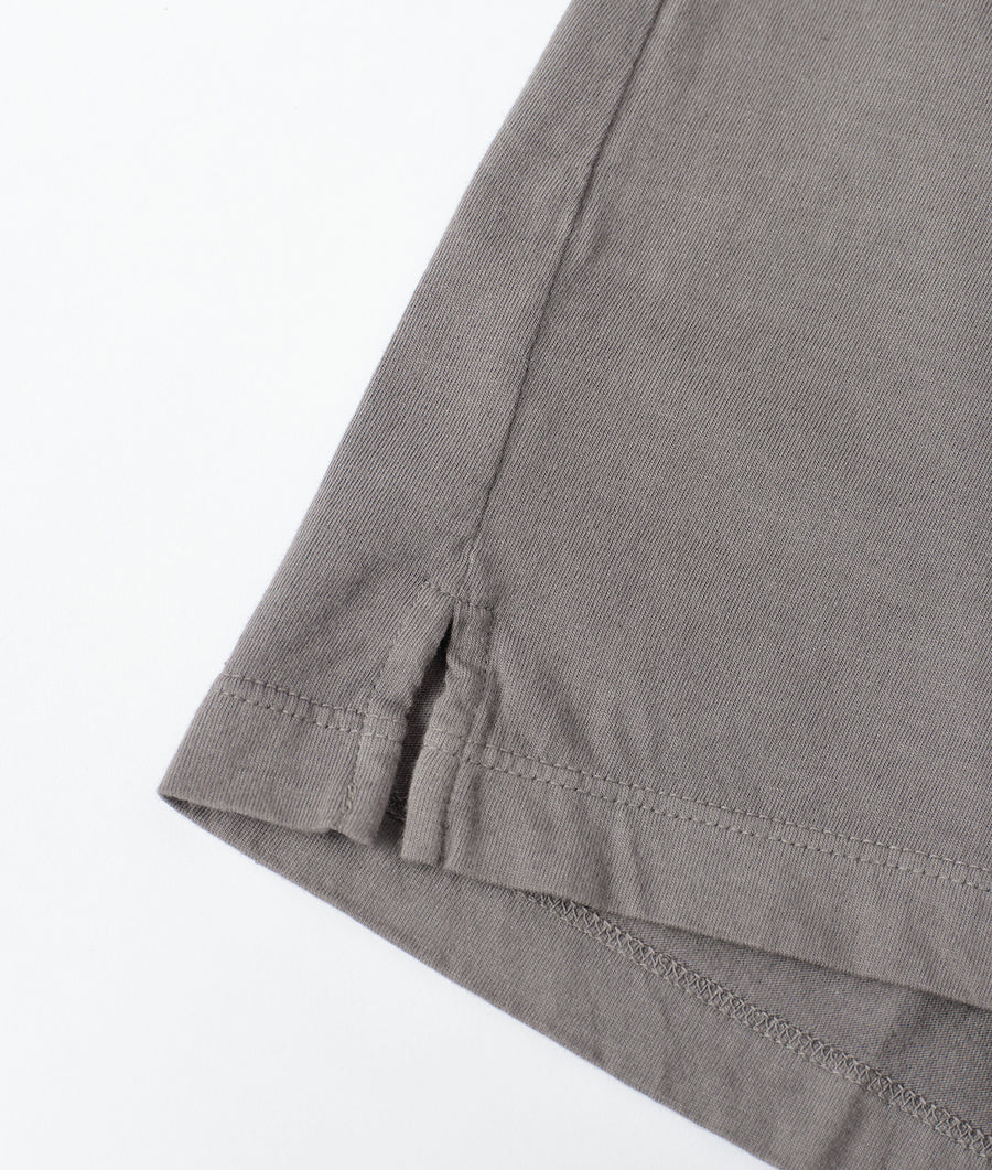 Closeup of the stitching detail on a gray organic cotton garment from Industry of All Nations.