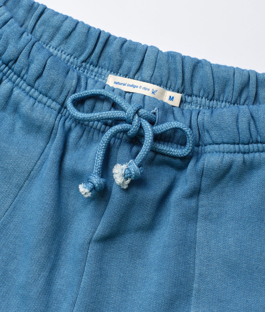 Detail shot of a pair of blue natural indigo drawstring pants with a waist tie - Industry of All Nations