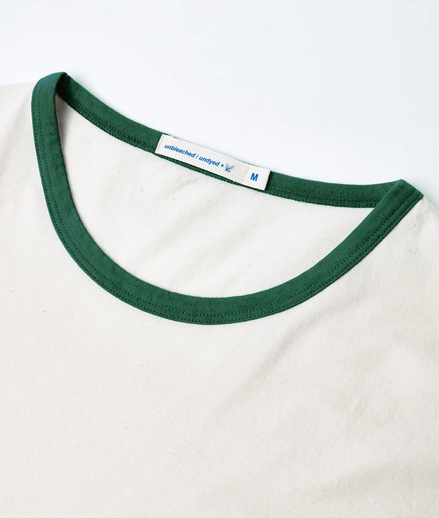 Close-up of IOAN Undyed Sport Crewneck T-shirt with green ribbed neckline, showing the inner neck label.