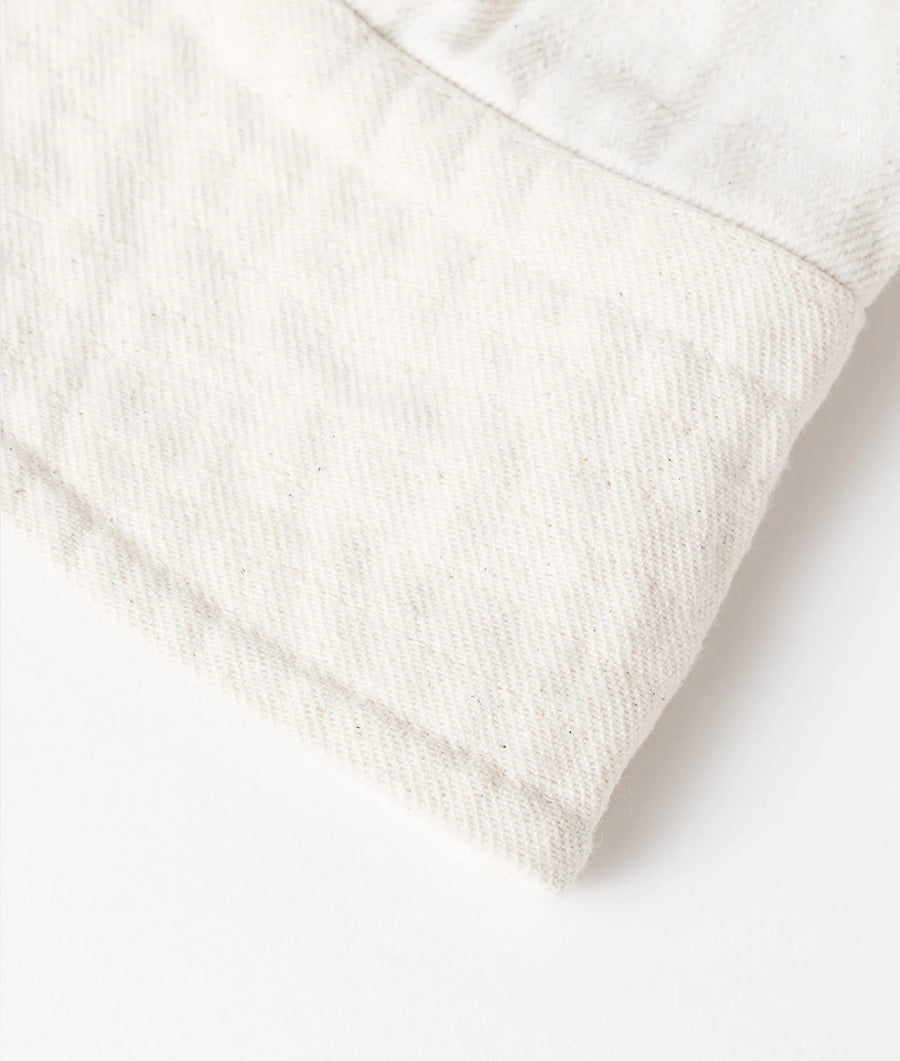 Flat lay detail shot of a white crewneck sweater made from organic cotton - Industry of All Nations