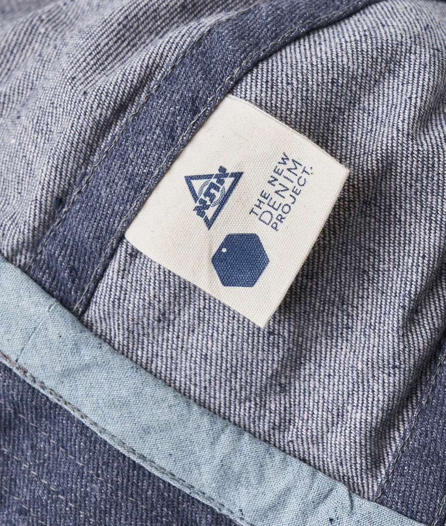 Detail shot of a grey cotton garment with a sewn-on label displaying the Industry of All Nations logo - Industry of All Nations