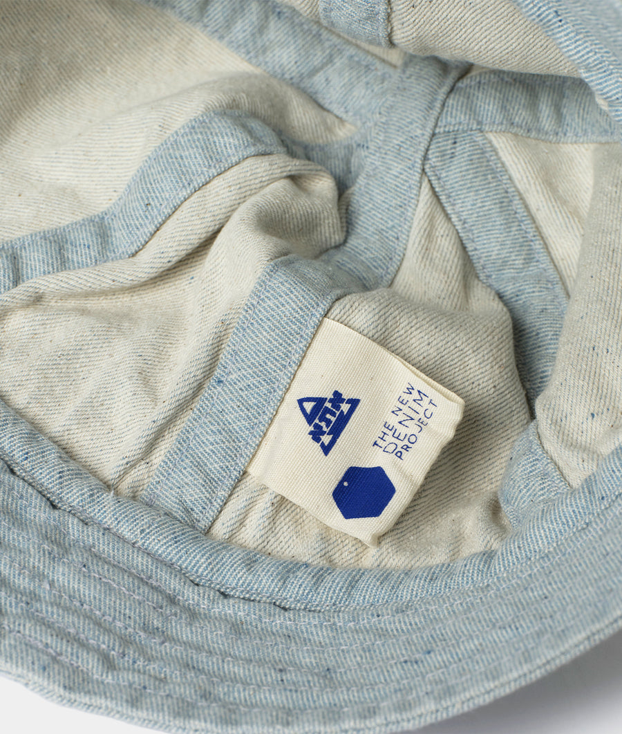 Detail shot of a beige and light blue patterned scarf with the Industry of All Nations logo - Industry of All Nations