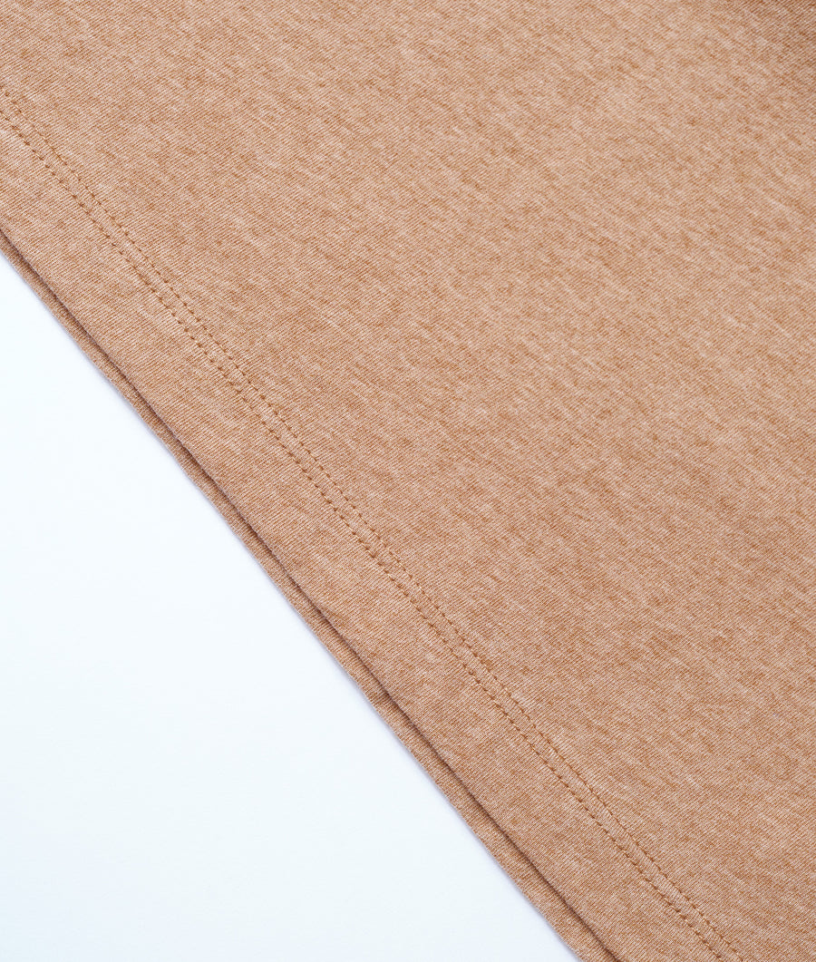 Closeup shot of brown organic cotton fabric with stitching detail - Industry of All Nations