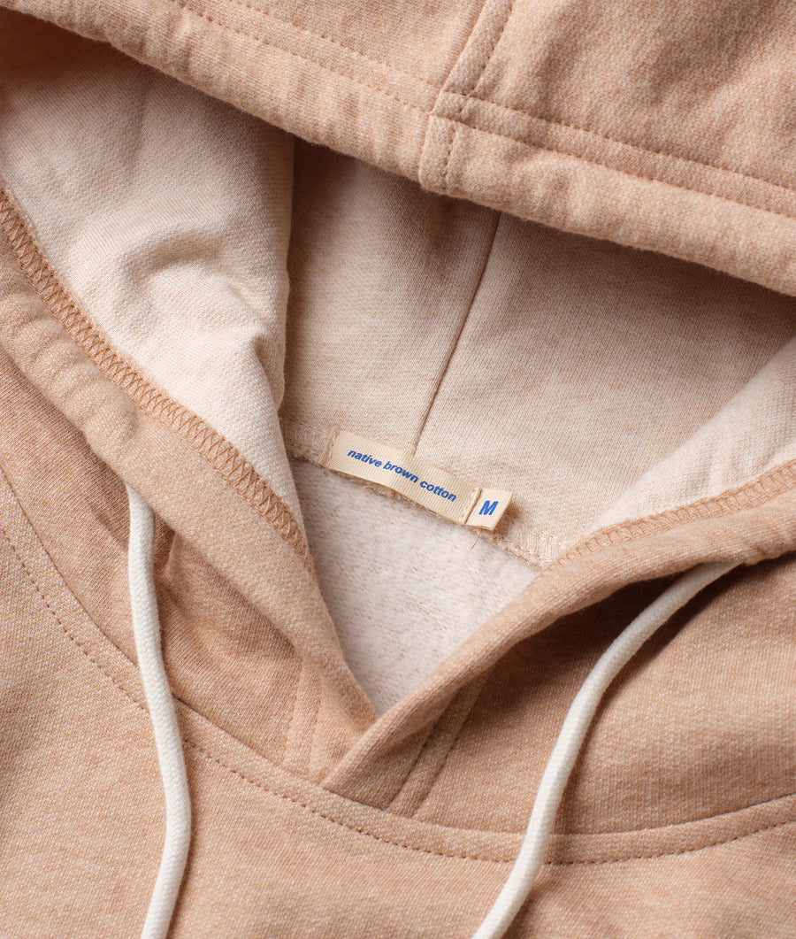 Close-up detail shot of a beige native cotton hoodie from Industry of All Nations.