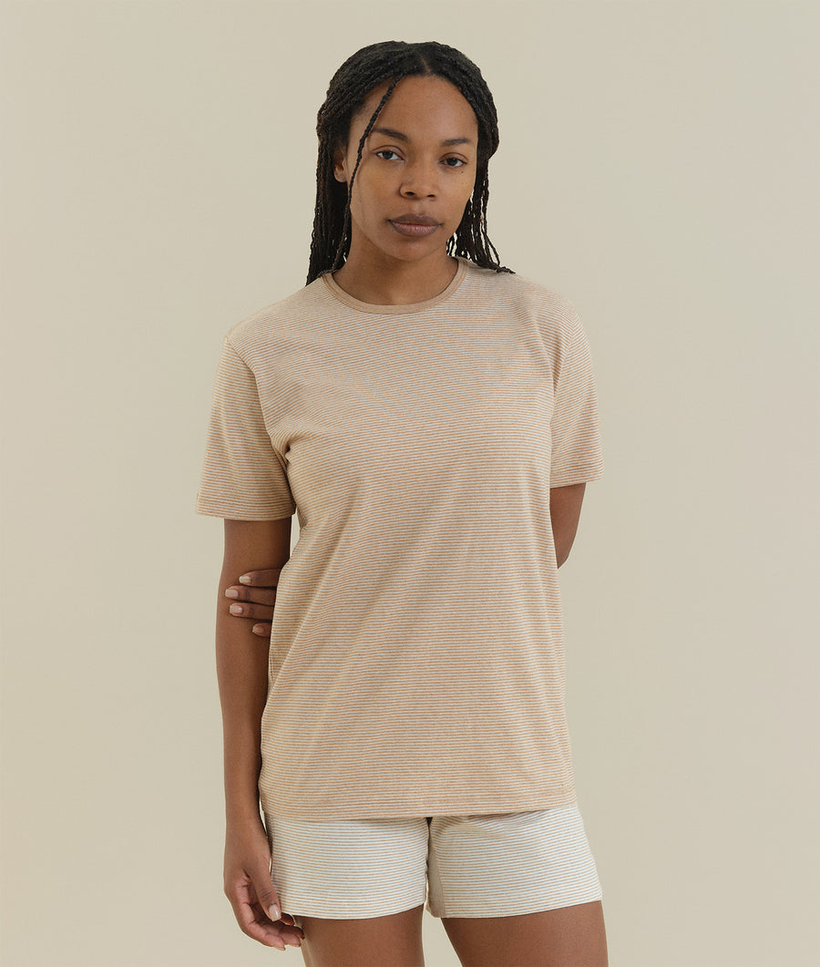 Beige striped crewneck t-shirt worn by a woman with braided hair - Industry of All Nations