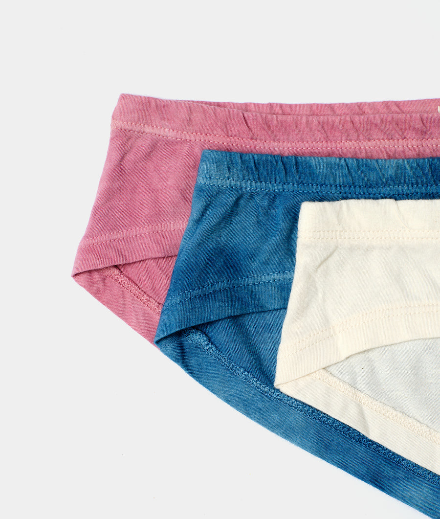 Detail shot of three organic cotton briefs in pink, blue, and cream - Industry of All Nations