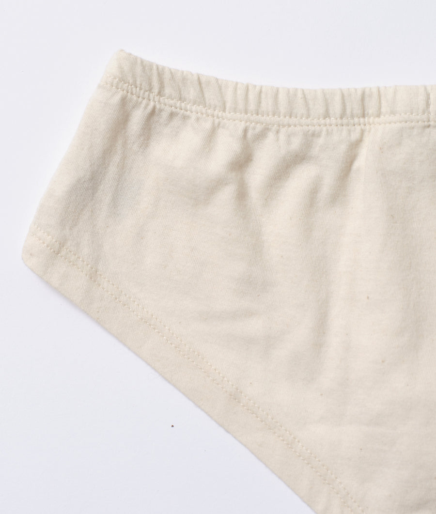 Close-up view of a pair of natural off-white/ivory organic cotton shorts displayed flat on a plain background - Industry of All Nations