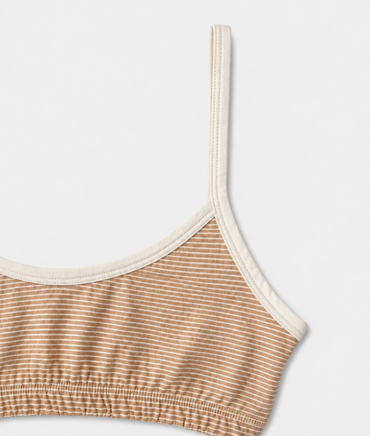 Close-up of the IOAN Wild Bralette in Ecru Stripe: ribbed organic cotton in tan and cream stripes with cream trim and straps