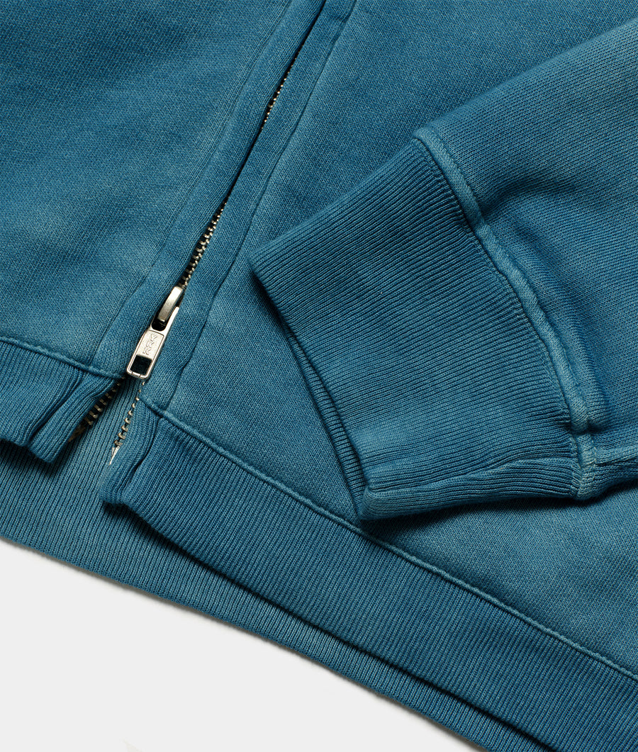 Detail shot of a zip-up teal blue knit hoodie - Industry of All Nations
