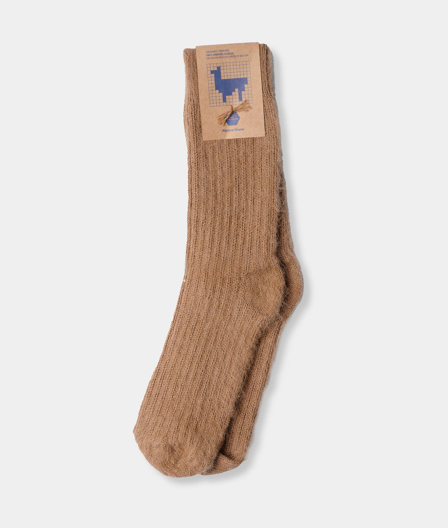 Beige ribbed cotton socks with a blue alpaca icon, displayed flat on a white background - Industry of All Nations