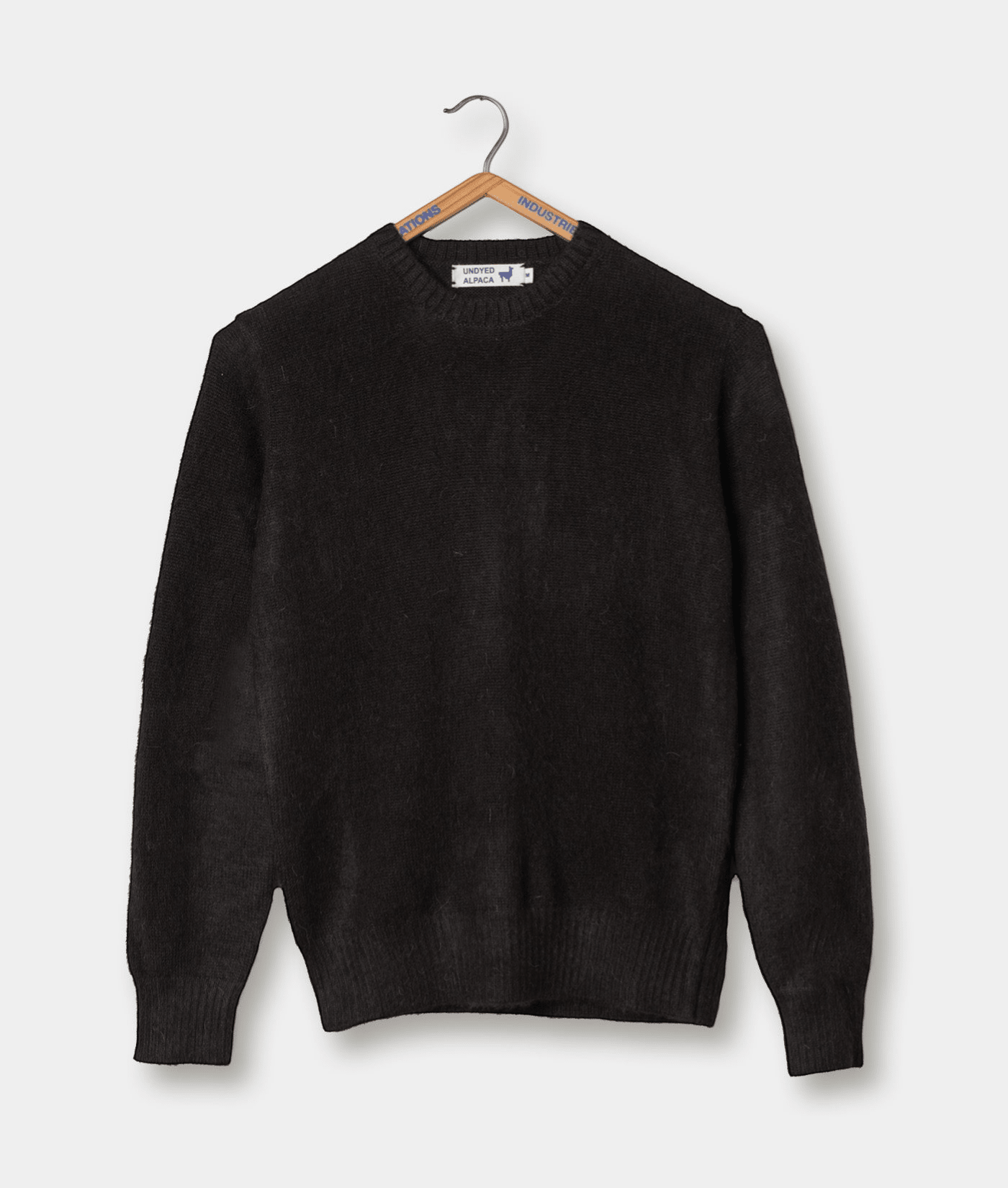 Black alpaca crewneck sweater displayed on a hanger - Industry of All Nations