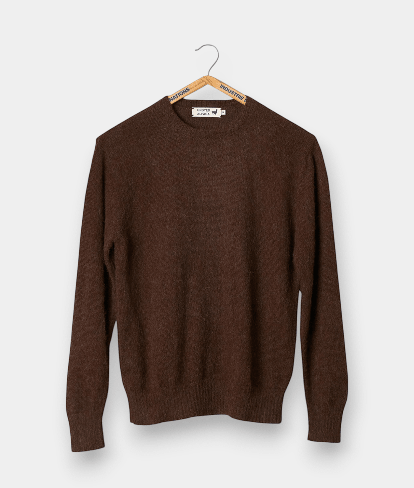 A brown wool sweater or pullover hanging on a wooden hanger - Industry of All Nations