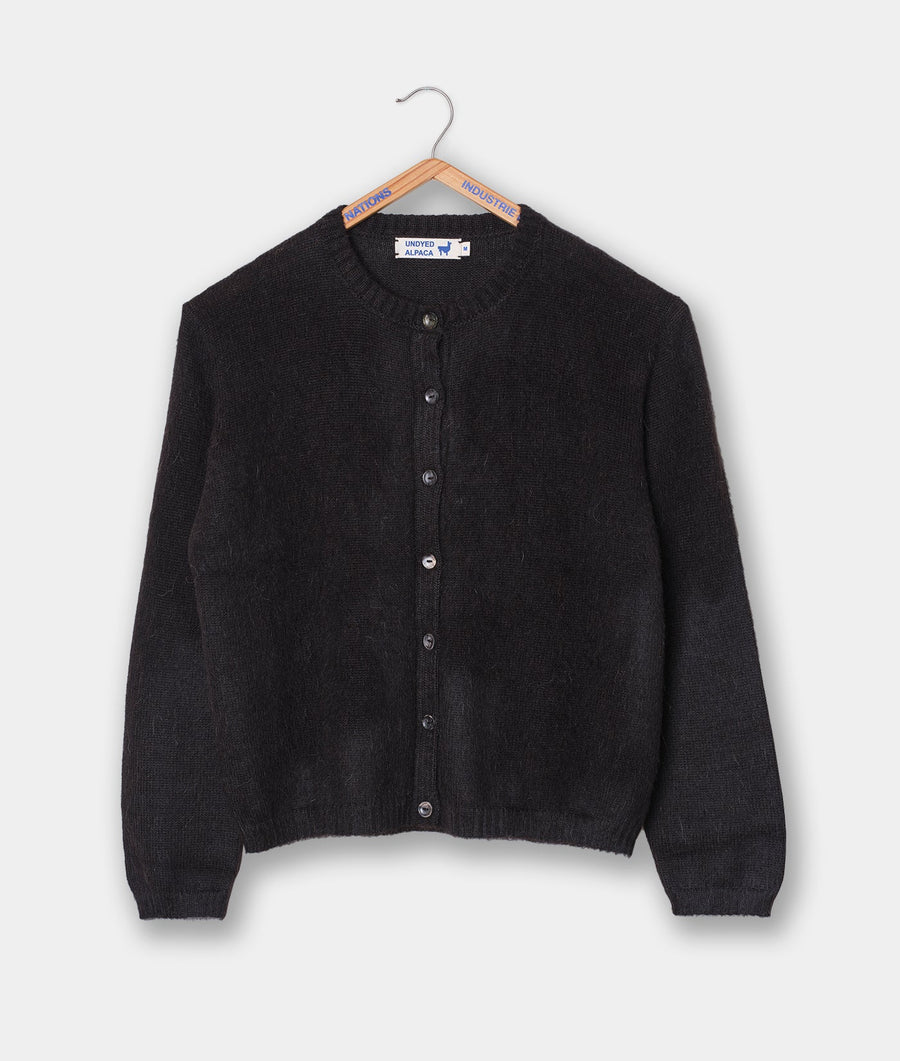 Black undyed alpaca cardigan sweater hung on a wooden hanger - Industry of All Nations